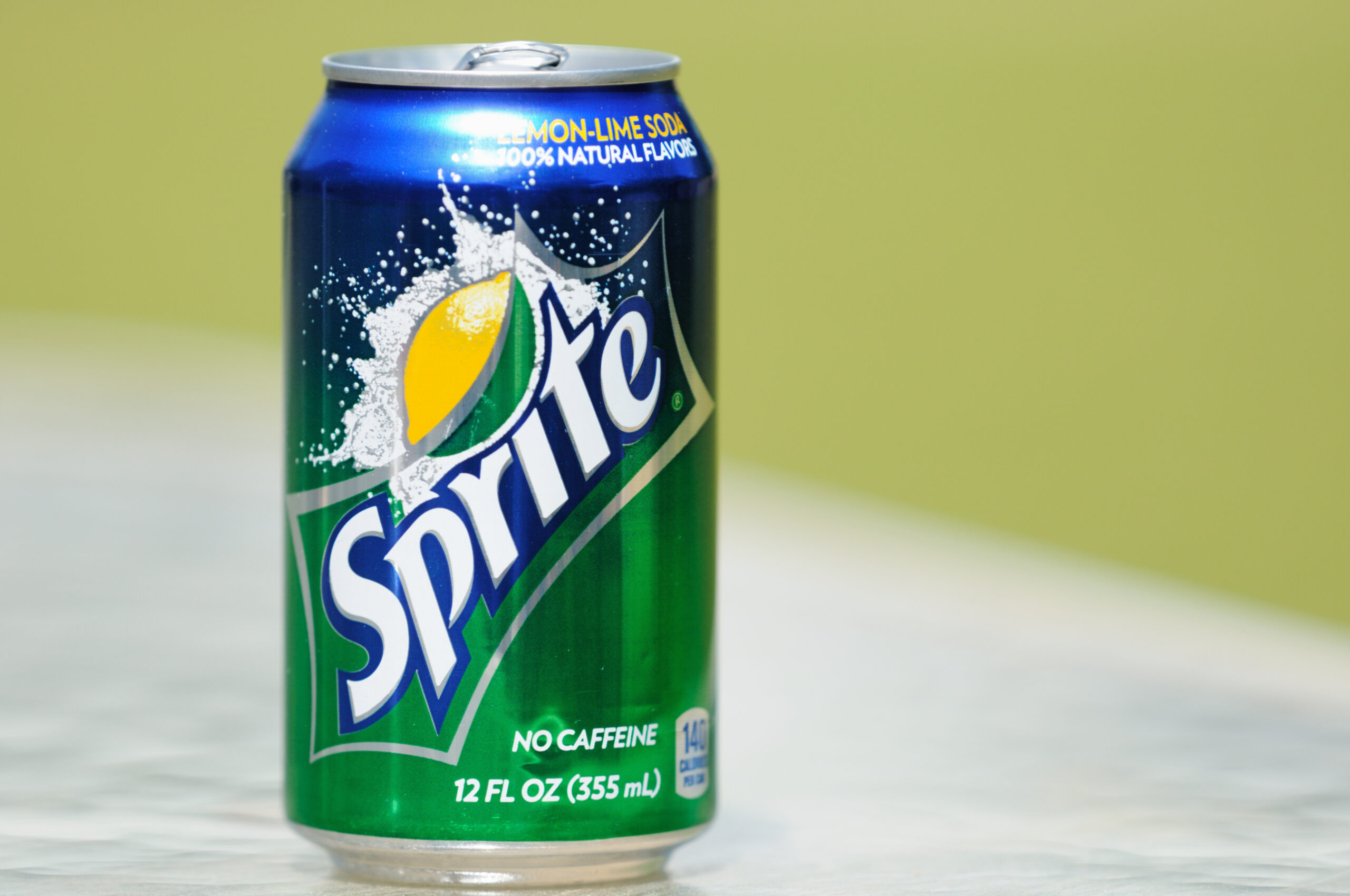 Northport, Alabama, USA - April 13, 2011: Close up of Sprite soda can in horizontal composition with out of focus background and copy space. Aluminum can sitting on glass table.