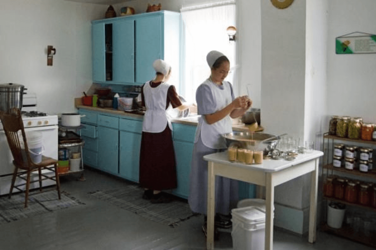 Two young amish woman cooking in the kitchen