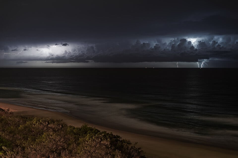 Lightning storm over ocean at night