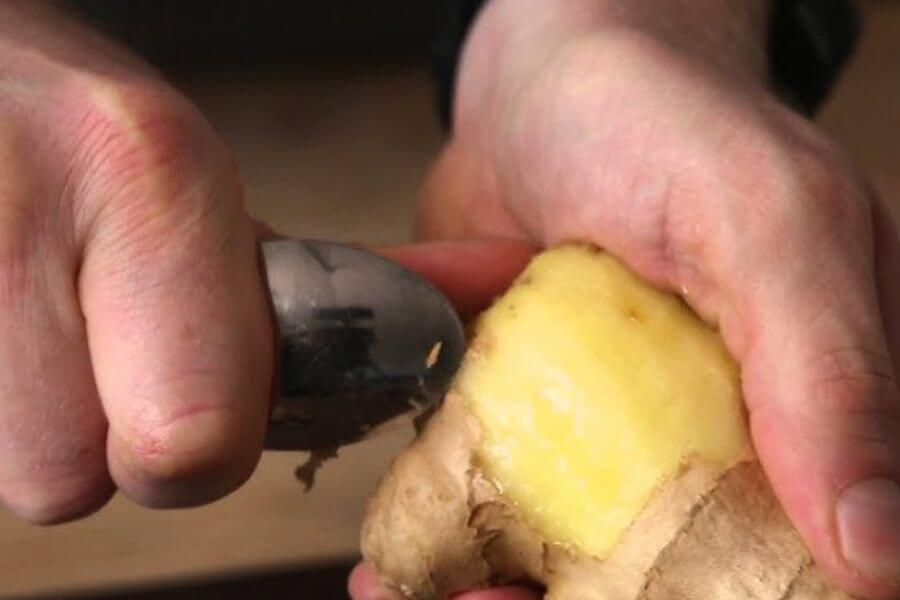 peeling ginger with a spoon