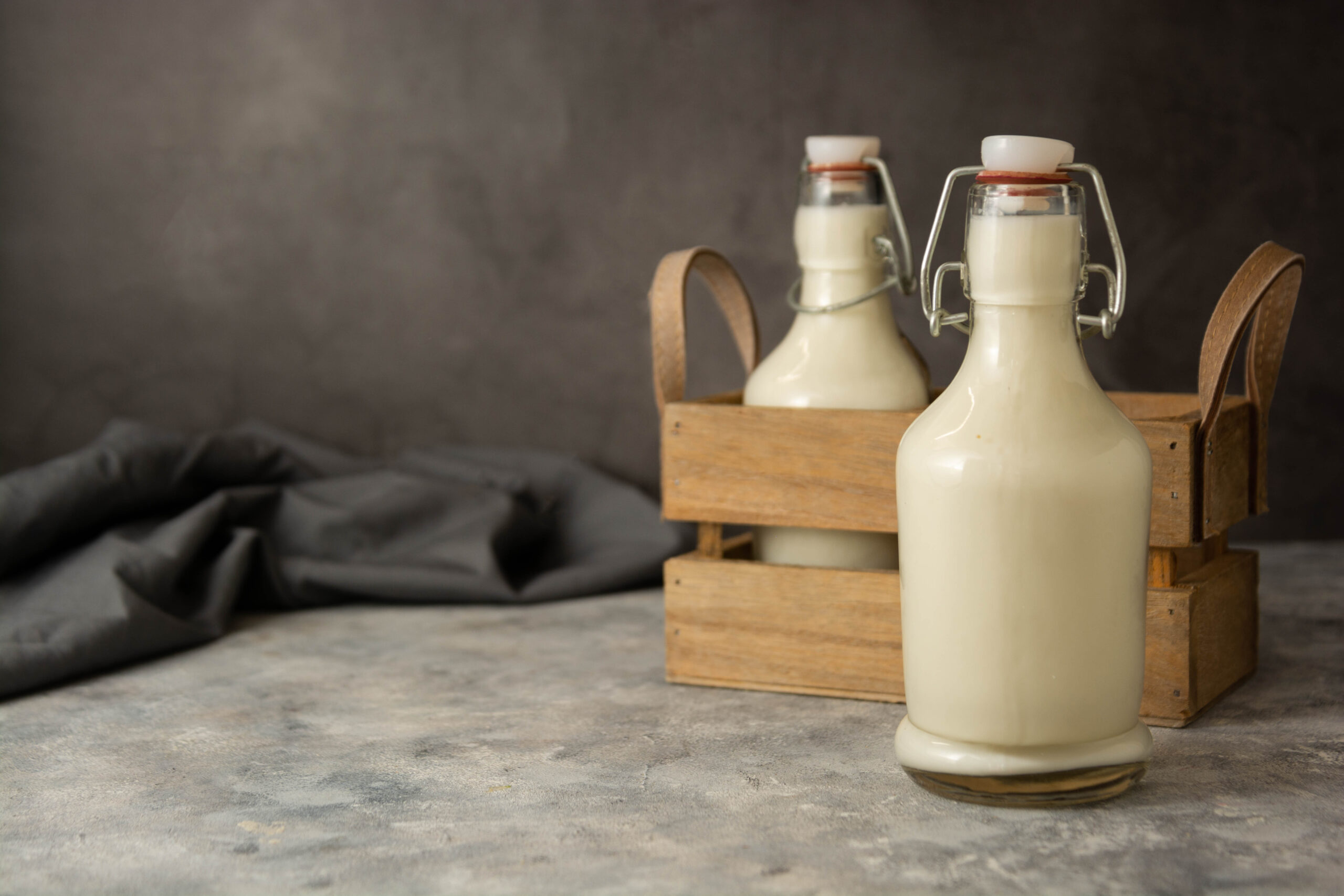 Milk Bottle glass on dark background, retro vintage styled glass milk bottle, diary products